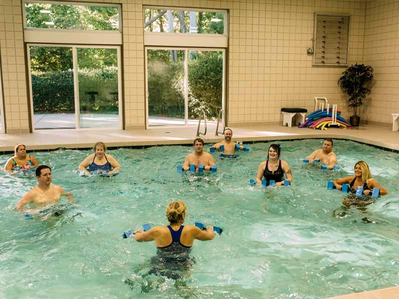 people in swimming pool doing exercise